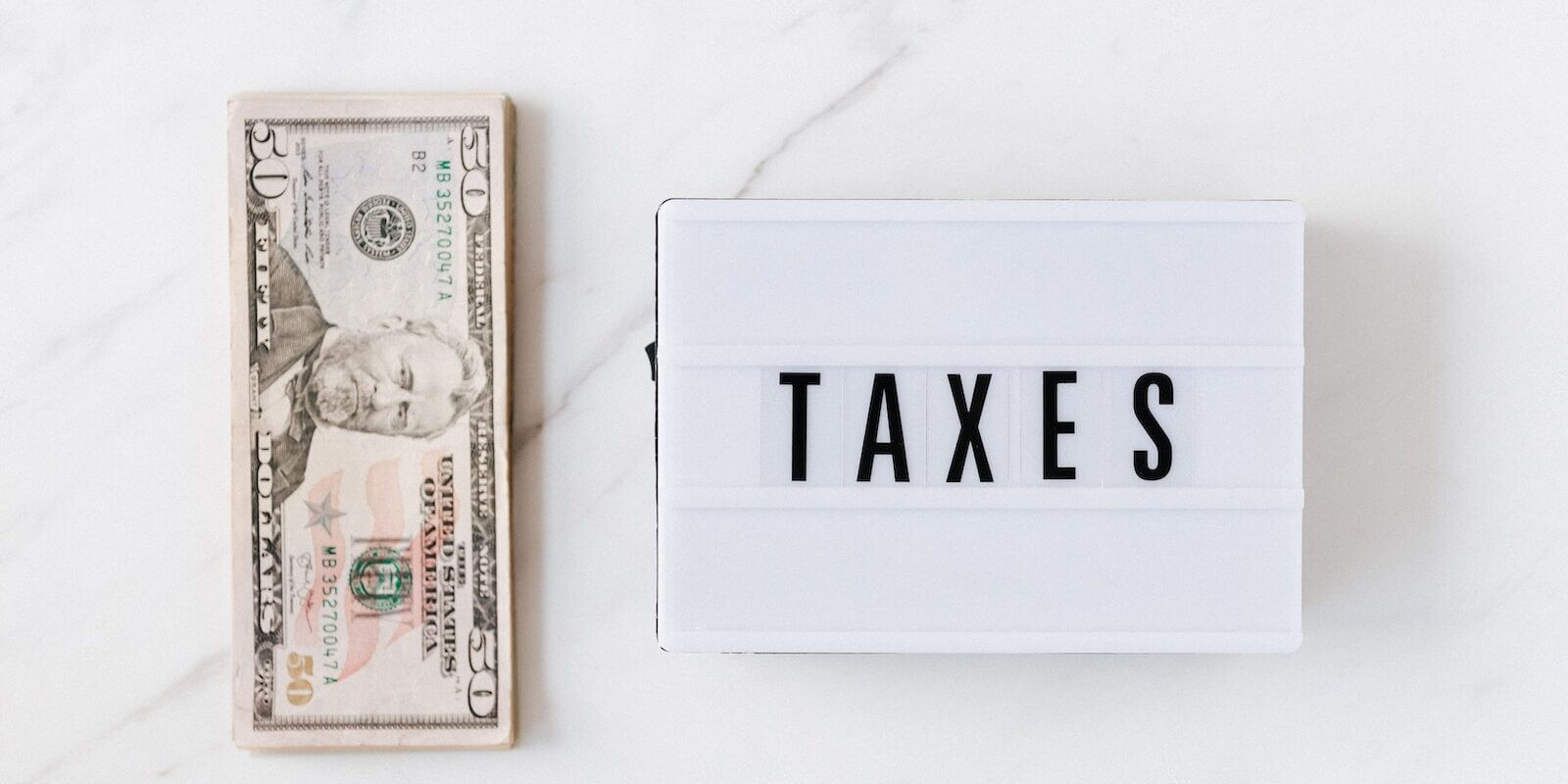 American dollar bills and vintage light box with inscription